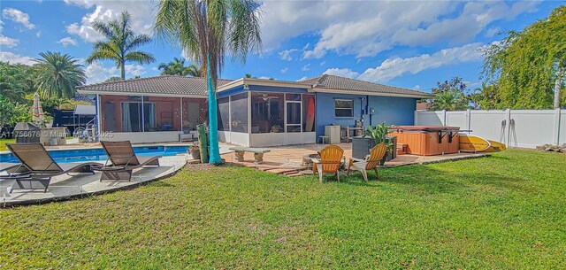 11400 Tara Dr, Plantation, FL 33325 - back of house with a hot tub, a sunroom, a fenced backyard, a patio, and a tiled roof