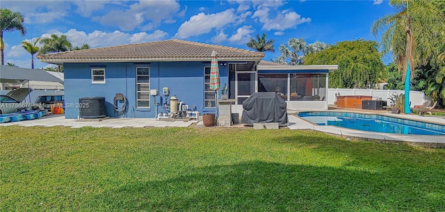 11400 Tara Dr, Plantation, FL 33325 - rear view of property featuring a hot tub, stucco siding, a sunroom, a lawn, and a patio