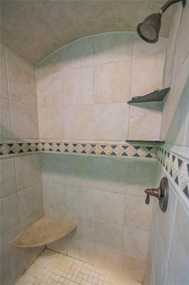 bathroom with a tile shower