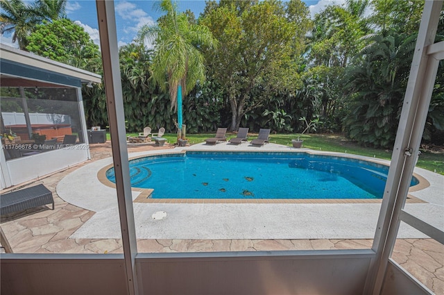 outdoor pool with a patio area and fence