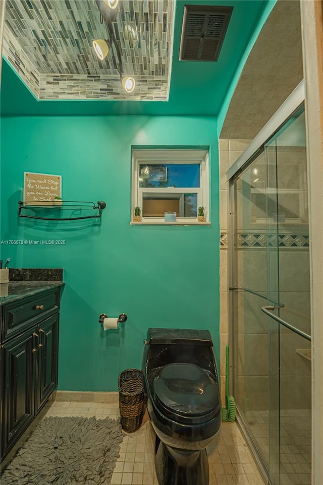 full bathroom featuring visible vents, toilet, a shower stall, vanity, and tile patterned flooring