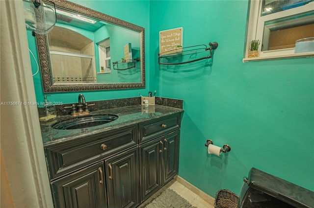 bathroom featuring vanity and baseboards