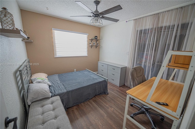 bedroom with a ceiling fan, dark wood finished floors, and a textured ceiling