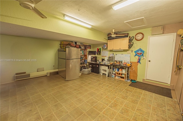 garage with a ceiling fan and freestanding refrigerator