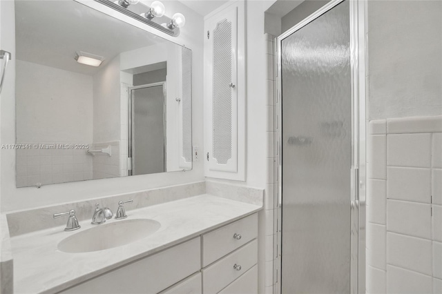 bathroom featuring a shower stall and vanity