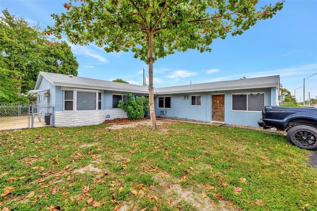 single story home with a garage, a front yard, fence, and stucco siding