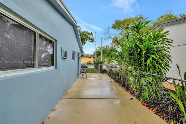 view of home's exterior with fence and stucco siding