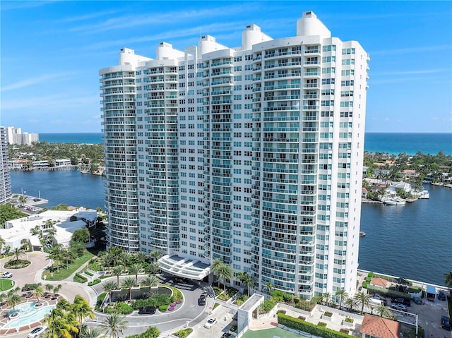 birds eye view of property with a water view and a city view