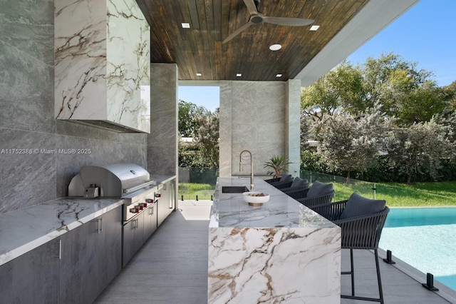 view of patio with an outdoor pool, a ceiling fan, area for grilling, grilling area, and a sink