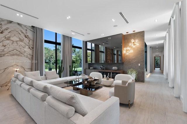 living room with stone wall, expansive windows, visible vents, and recessed lighting