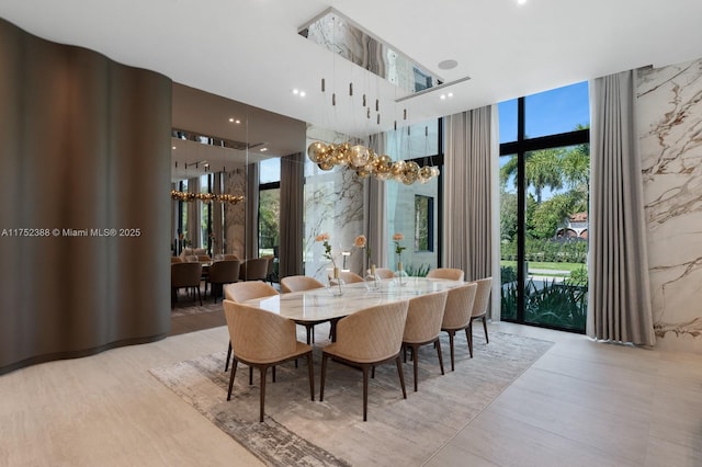 dining space featuring a healthy amount of sunlight and floor to ceiling windows