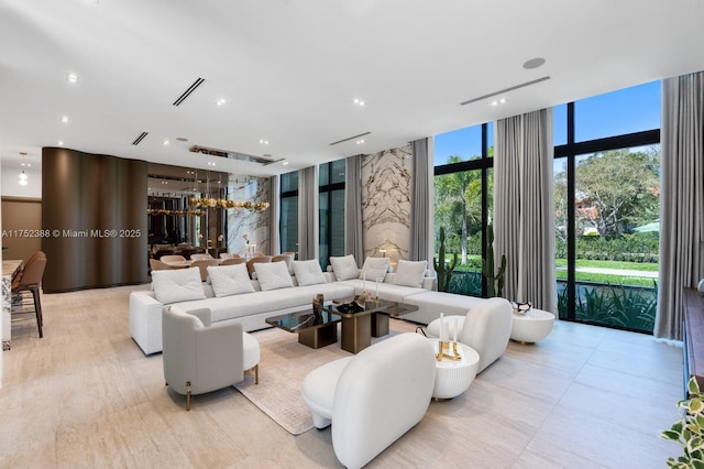 living area featuring recessed lighting, visible vents, and floor to ceiling windows