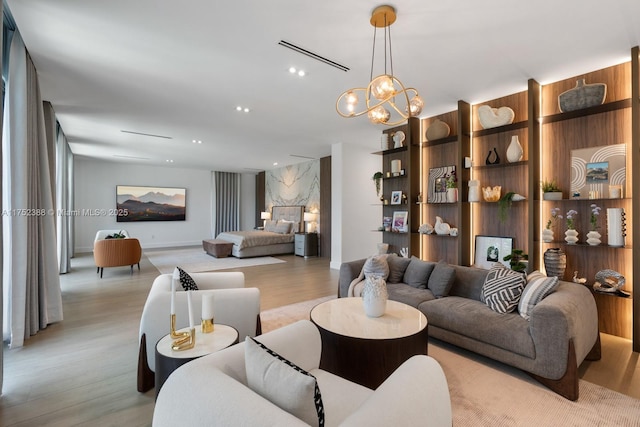 living area with light wood finished floors, recessed lighting, visible vents, and a notable chandelier