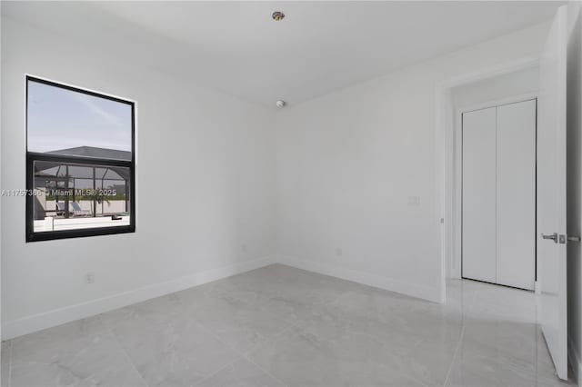 spare room featuring baseboards