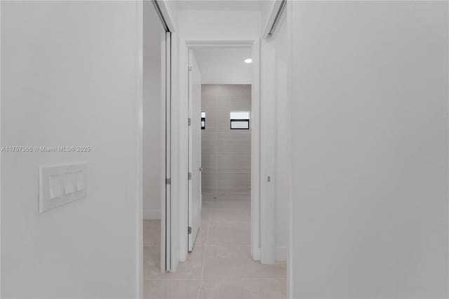 hall featuring light tile patterned floors