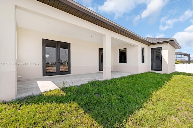 back of house with a patio, french doors, and stucco siding