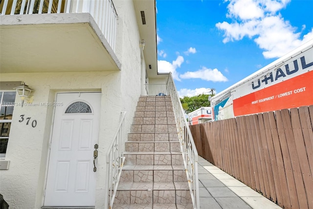 doorway to property with stucco siding