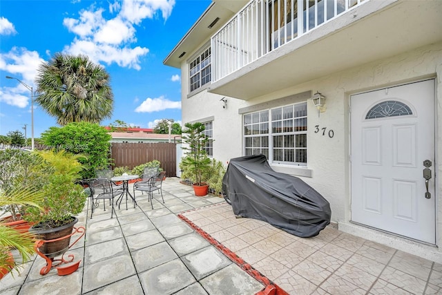 view of patio / terrace with outdoor dining space, grilling area, fence, and a balcony