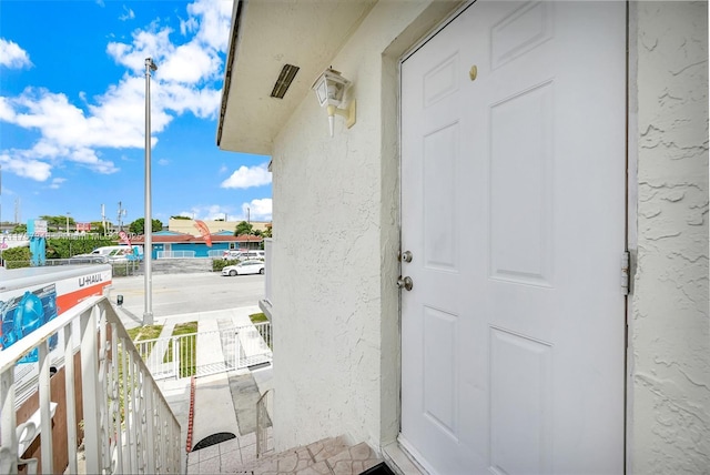 view of exterior entry featuring stucco siding