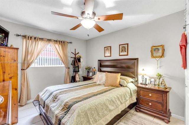 bedroom with a ceiling fan, baseboards, and light tile patterned floors