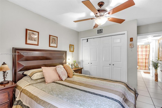 bedroom with a ceiling fan, a closet, visible vents, and light tile patterned floors