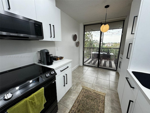 kitchen with white cabinets, light countertops, a textured ceiling, and black / electric stove