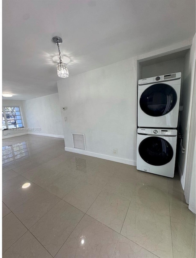 2318 Scott St, Hollywood, FL 33020 - laundry room with stacked washer / drying machine and tile patterned flooring