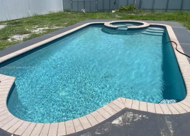 2318 Scott St, Hollywood, FL 33020 - view of pool featuring a pool with connected hot tub and a fenced backyard