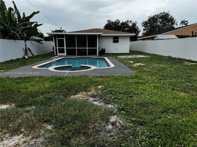 2318 Scott St, Hollywood, FL 33020 - rear view of property with an in-ground hot tub, a sunroom, and a fenced backyard