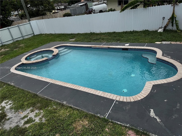 2318 Scott St, Hollywood, FL 33020 - view of pool featuring a pool with connected hot tub and a fenced backyard