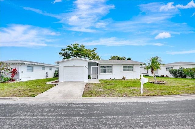 single story home featuring a garage, concrete driveway, and a front yard