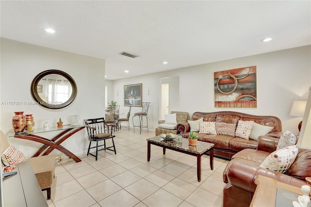 living room with recessed lighting, light tile patterned flooring, and visible vents