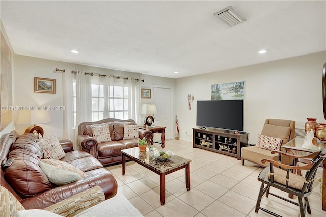 living room with light tile patterned floors, visible vents, and recessed lighting