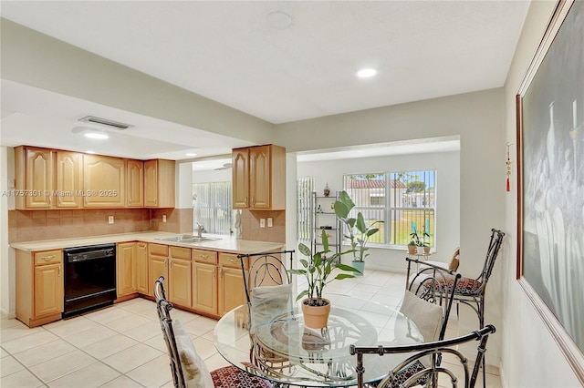 kitchen with dishwasher, light tile patterned floors, a sink, and decorative backsplash