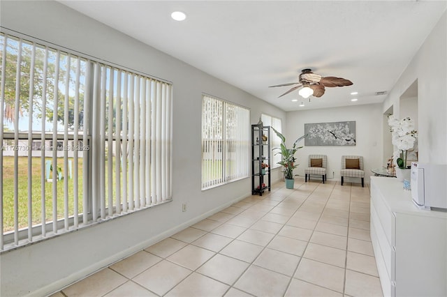 unfurnished sunroom with plenty of natural light, visible vents, and ceiling fan