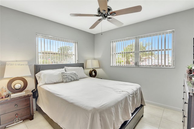 bedroom with a ceiling fan, light tile patterned flooring, and baseboards