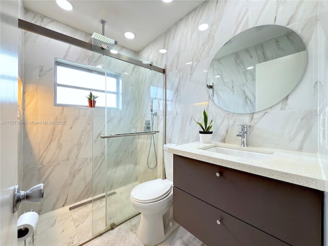 full bath featuring a marble finish shower, visible vents, tile walls, and vanity