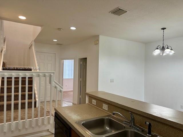 kitchen with black dishwasher, a sink, visible vents, and recessed lighting