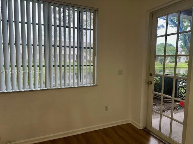 entryway featuring wood finished floors and baseboards