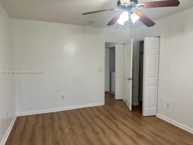 unfurnished room featuring ceiling fan, baseboards, and wood finished floors