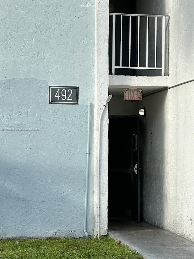 property entrance with stucco siding