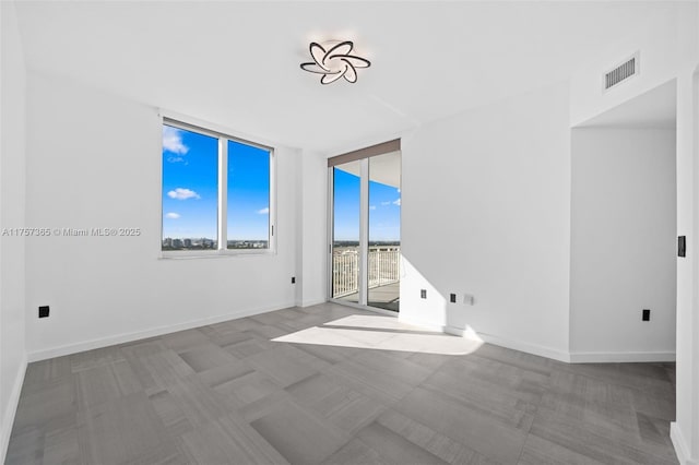 spare room with visible vents and baseboards