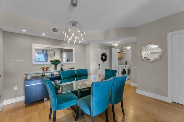 dining space featuring hardwood / wood-style flooring, independent washer and dryer, visible vents, and baseboards