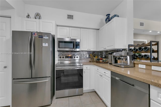 kitchen featuring white cabinetry, visible vents, stainless steel appliances, and light tile patterned flooring