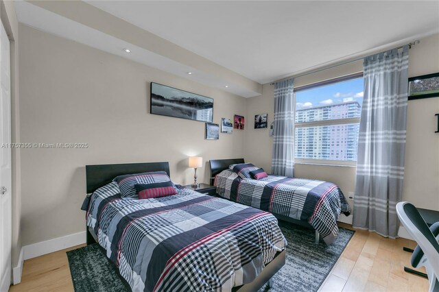 bedroom featuring light wood finished floors, a closet, visible vents, and baseboards