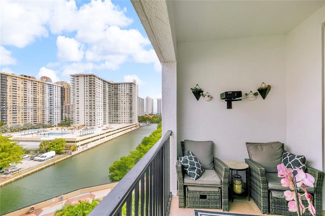 balcony with a water view and a city view