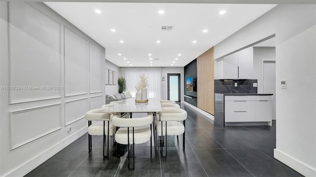 603 N 32nd Ave, Hollywood, FL 33021 - dining space with visible vents, baseboards, a decorative wall, and recessed lighting
