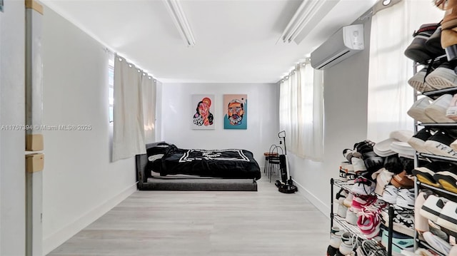 603 N 32nd Ave, Hollywood, FL 33021 - bedroom featuring a wall unit AC, wood finished floors, and baseboards