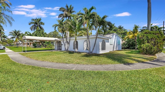 603 N 32nd Ave, Hollywood, FL 33021 - view of front of house with a carport, a front yard, and stucco siding