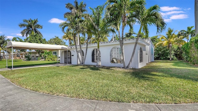 603 N 32nd Ave, Hollywood, FL 33021 - view of front of house featuring a front yard, an attached carport, and stucco siding